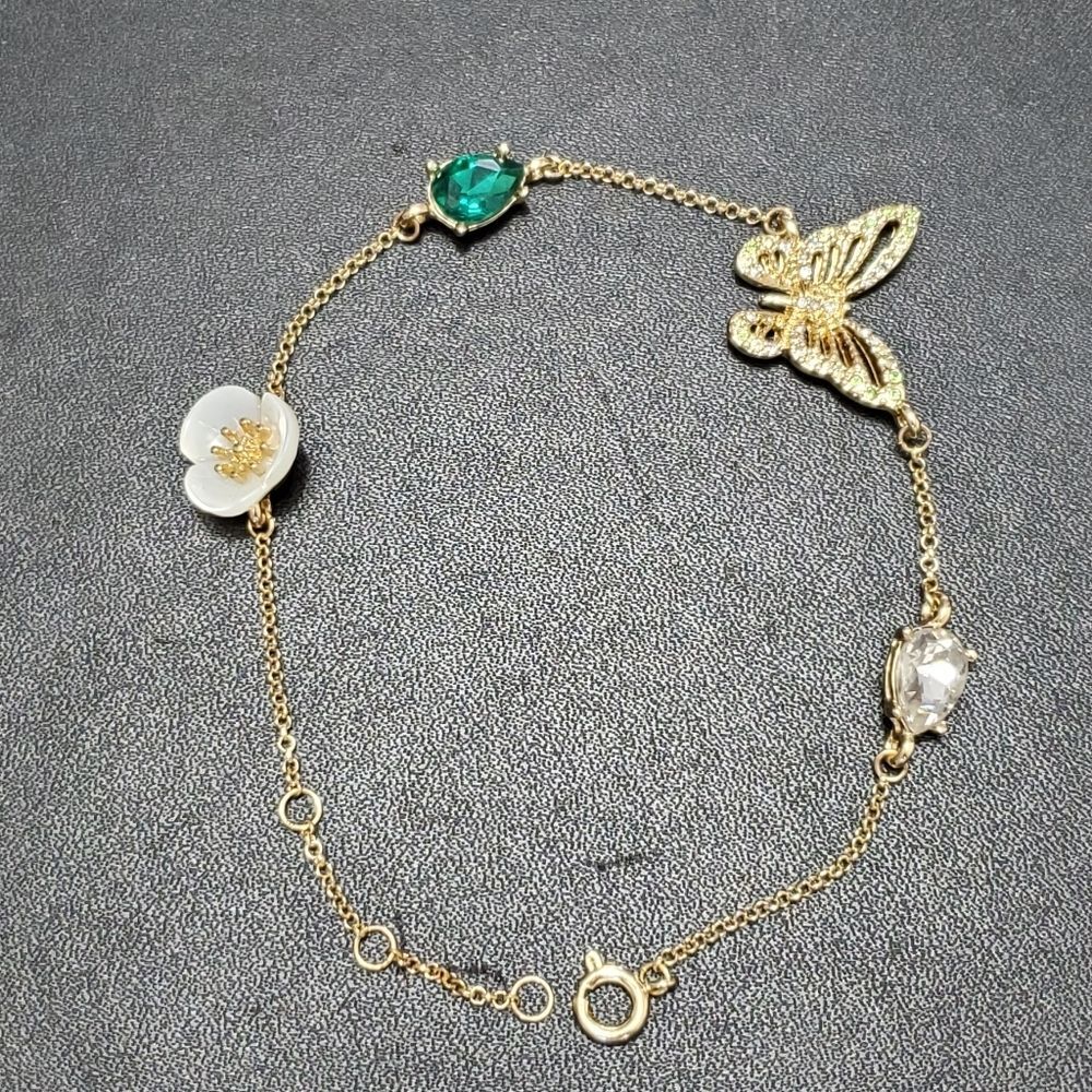Gold tone butterfly and flower bracelet 8-9.5" green white